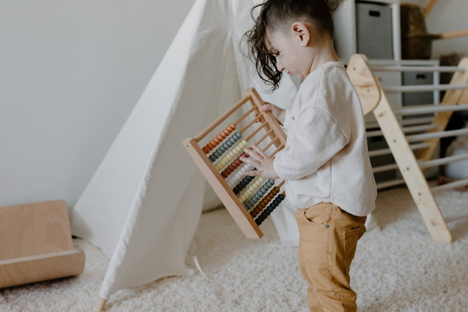 Young child learns with a wooden abacus in a cozy, indoor playroom setting.